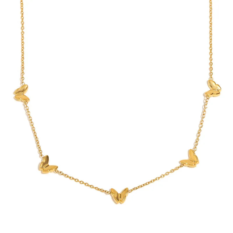 Close-up of delicate gold butterfly charms along a fine chain necklace