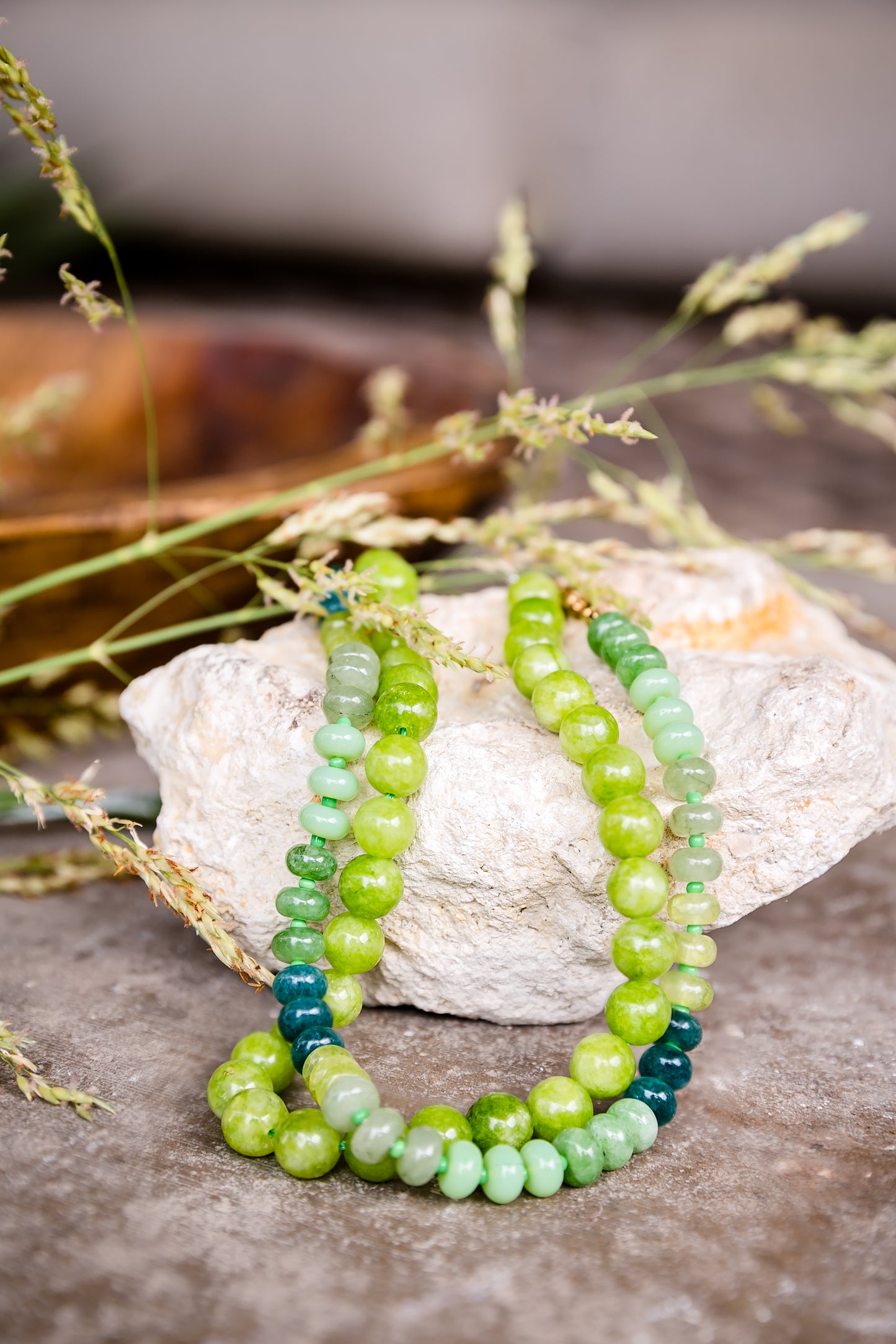 Close-up of the Arden Necklace and Peridot Necklace showing genuine green stones and hand-knotted silk thread detail