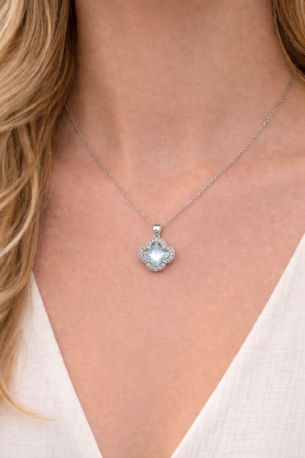 Silver Necklace with a clover-shaped pendant worn by a person