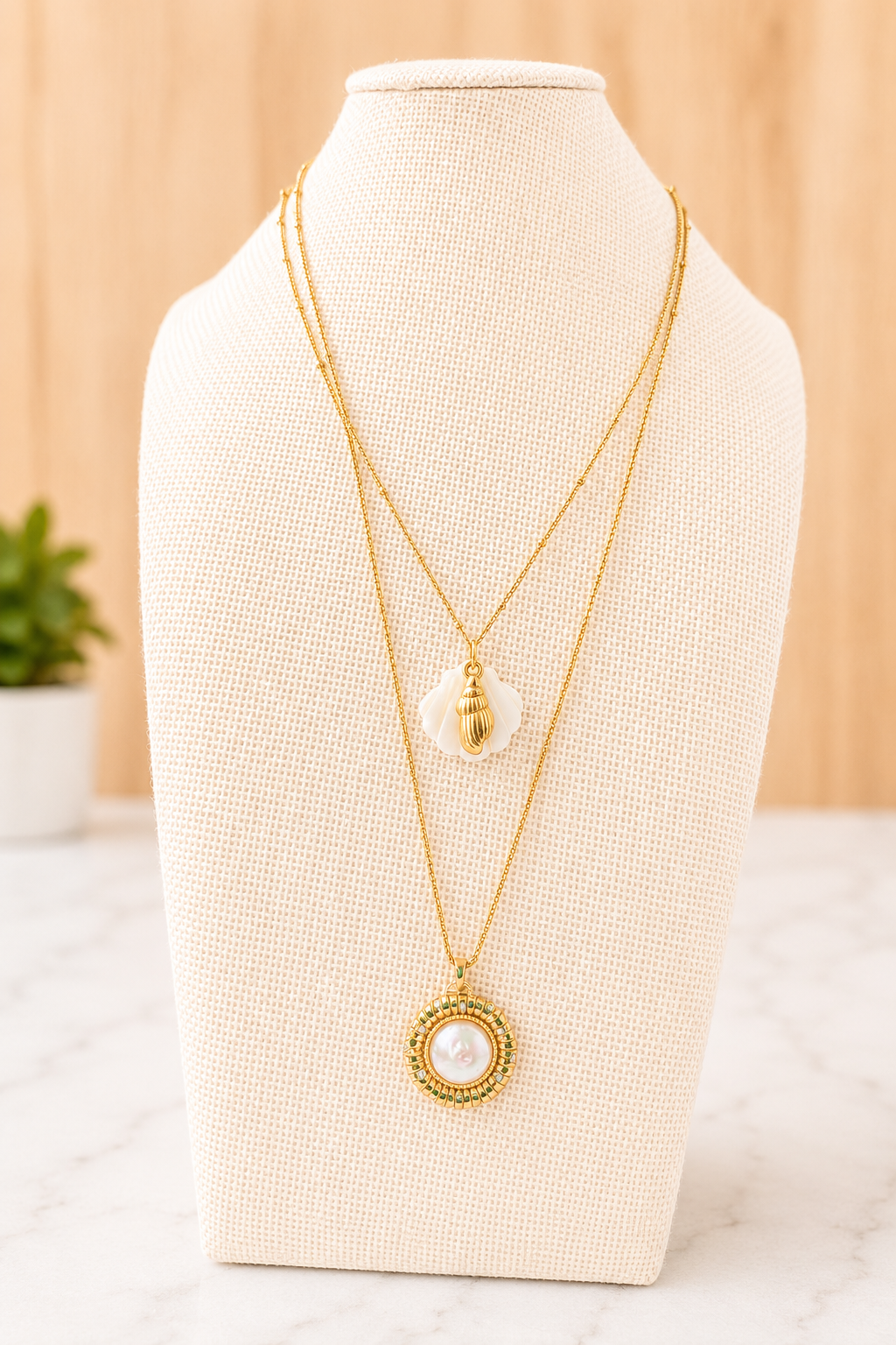 Il Tesoro Necklace styled layered with another gold chain, featuring a luminous mother of pearl pendant for an effortlessly elegant look.