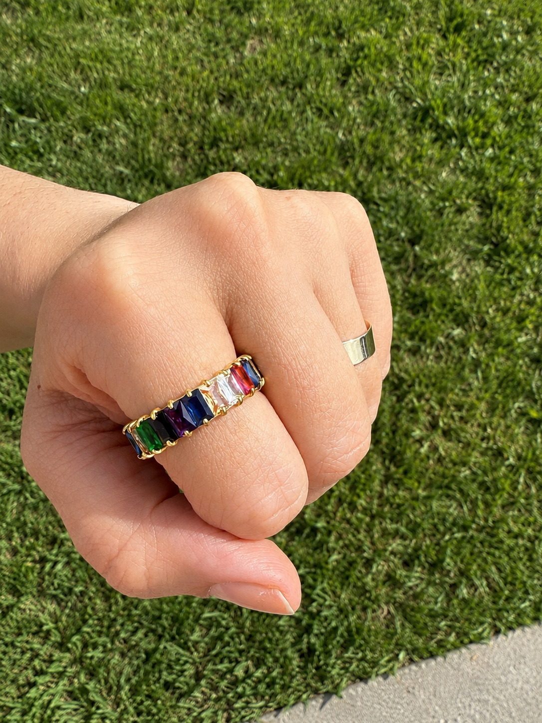 Model wearing the Fiona Rainbow Ring with multicolor baguette gemstones on gold band