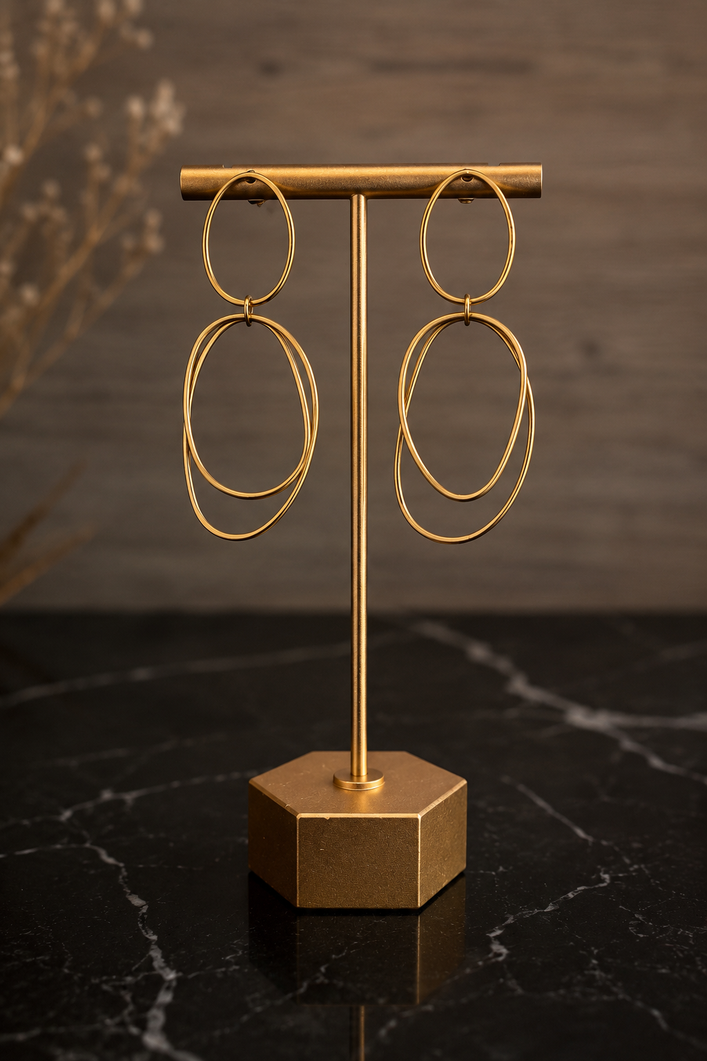 Afterglow Earrings featuring elongated organic gold hoops crafted from stainless steel with 18kt gold PVD plating.