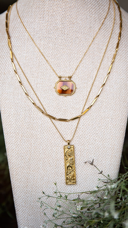 VEITA Jewelry Alchemy Collection Fall 2026 layered necklace look featuring the Ambra Necklace with gold chains