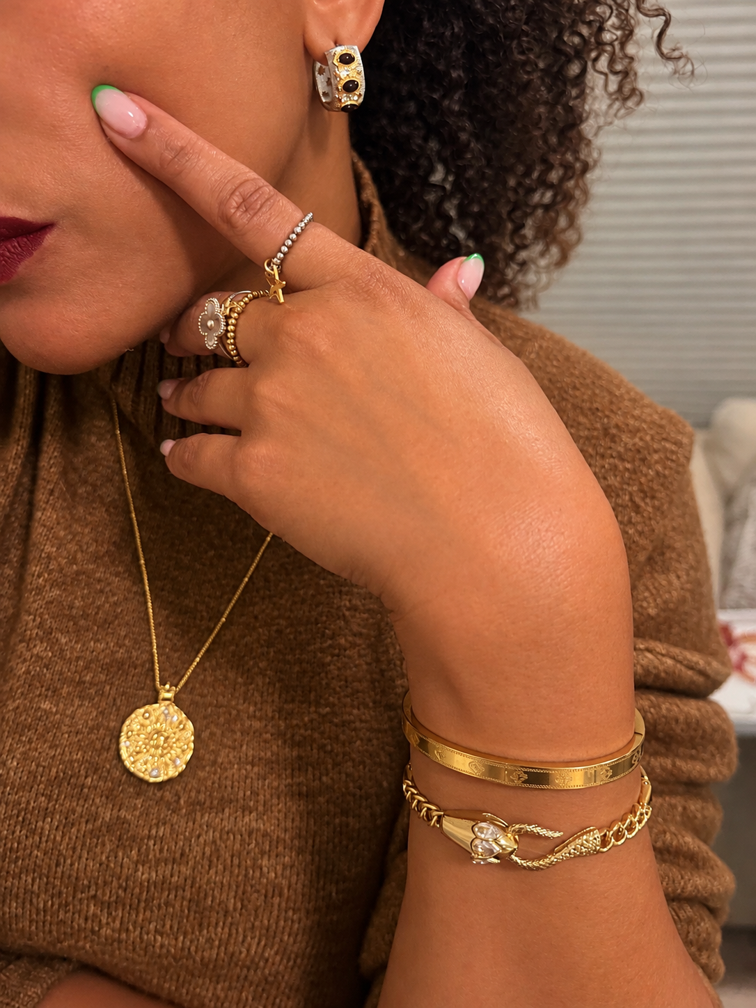 VEITA Jewelry Ouro Bangle styled on wrist with layered gold bracelets