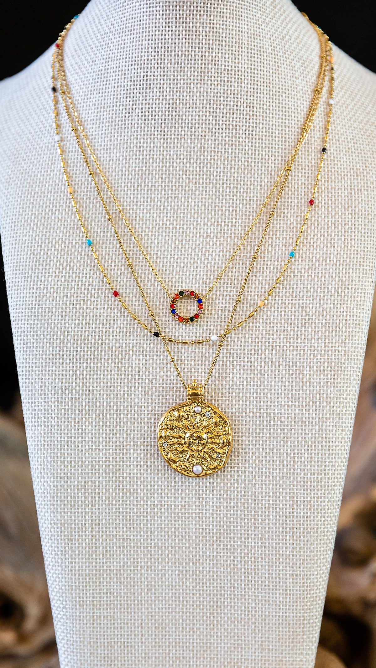 Gold necklaces layered on a display as part of the VEITA Jewelry Alchemy Collection Fall 2026