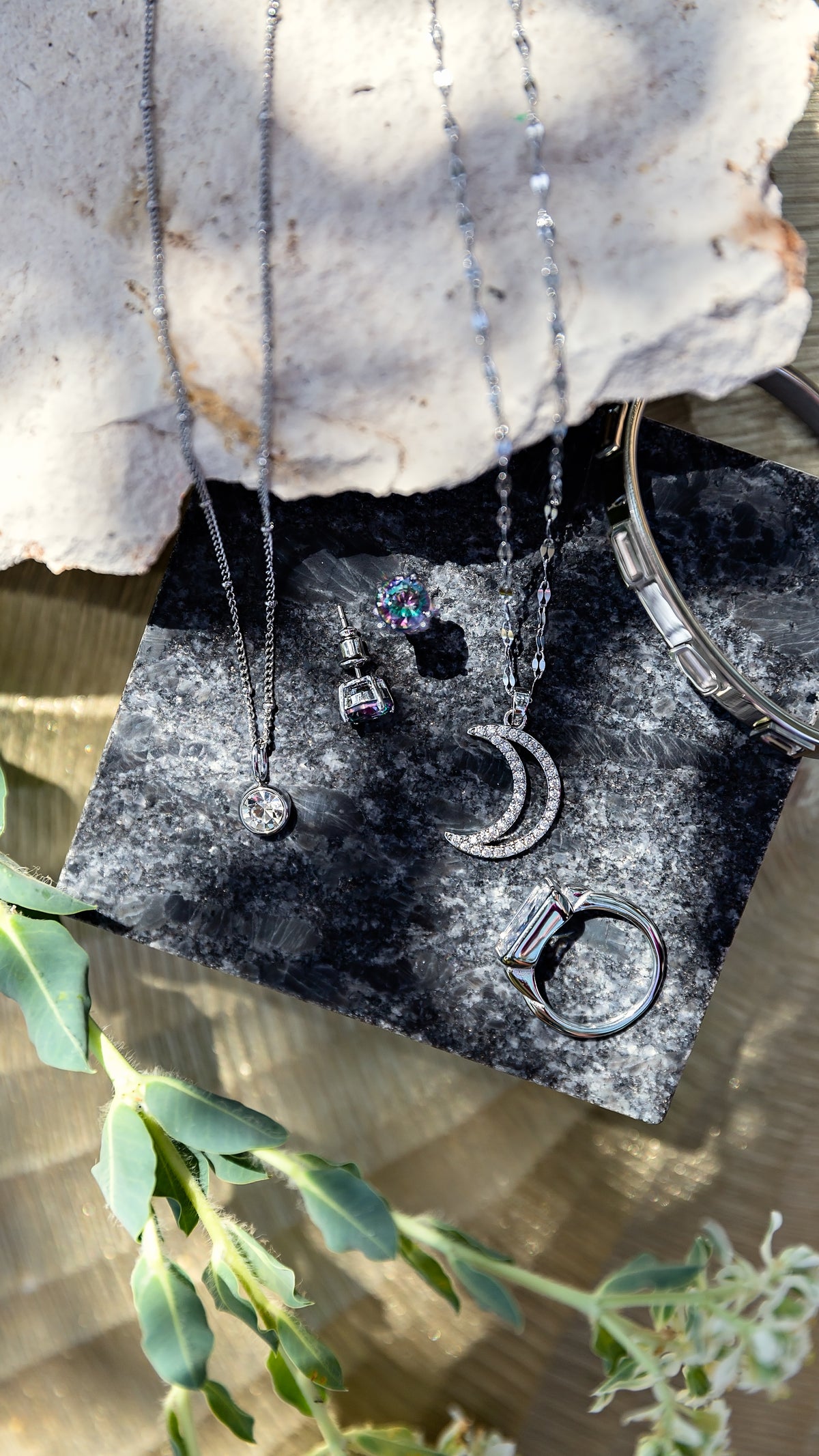 Assortment of jewelry from the Alchemy LUNA Collection by VEITA Jewelry featuring mixed-metal necklaces and celestial-inspired pieces styled together.