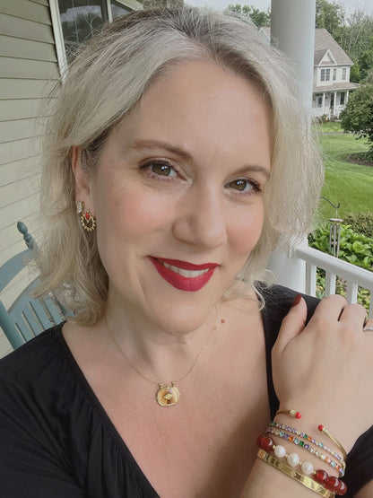 VEITA Jewelry Ambra Necklace worn on model featuring a delicate gold chain and warm amber-hued pendant