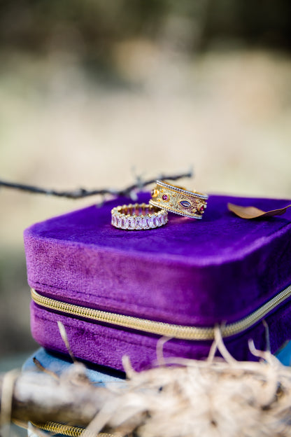Purple velvet jewelry box with two rings on a natural background