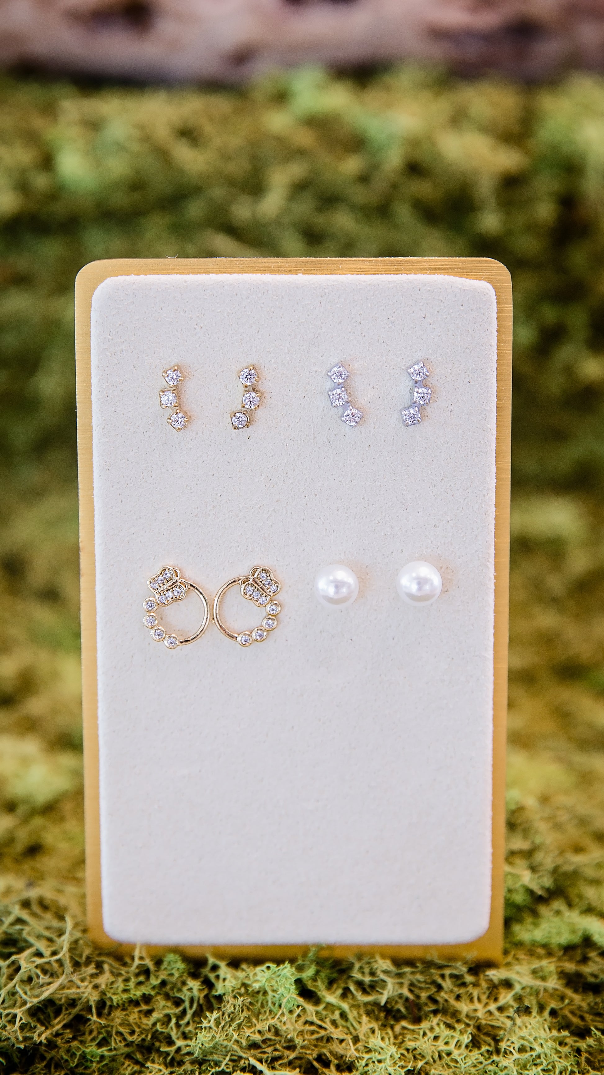 Annie micro stud earrings (top) displayed on a jewelry card, showing size and styling for multiple piercings