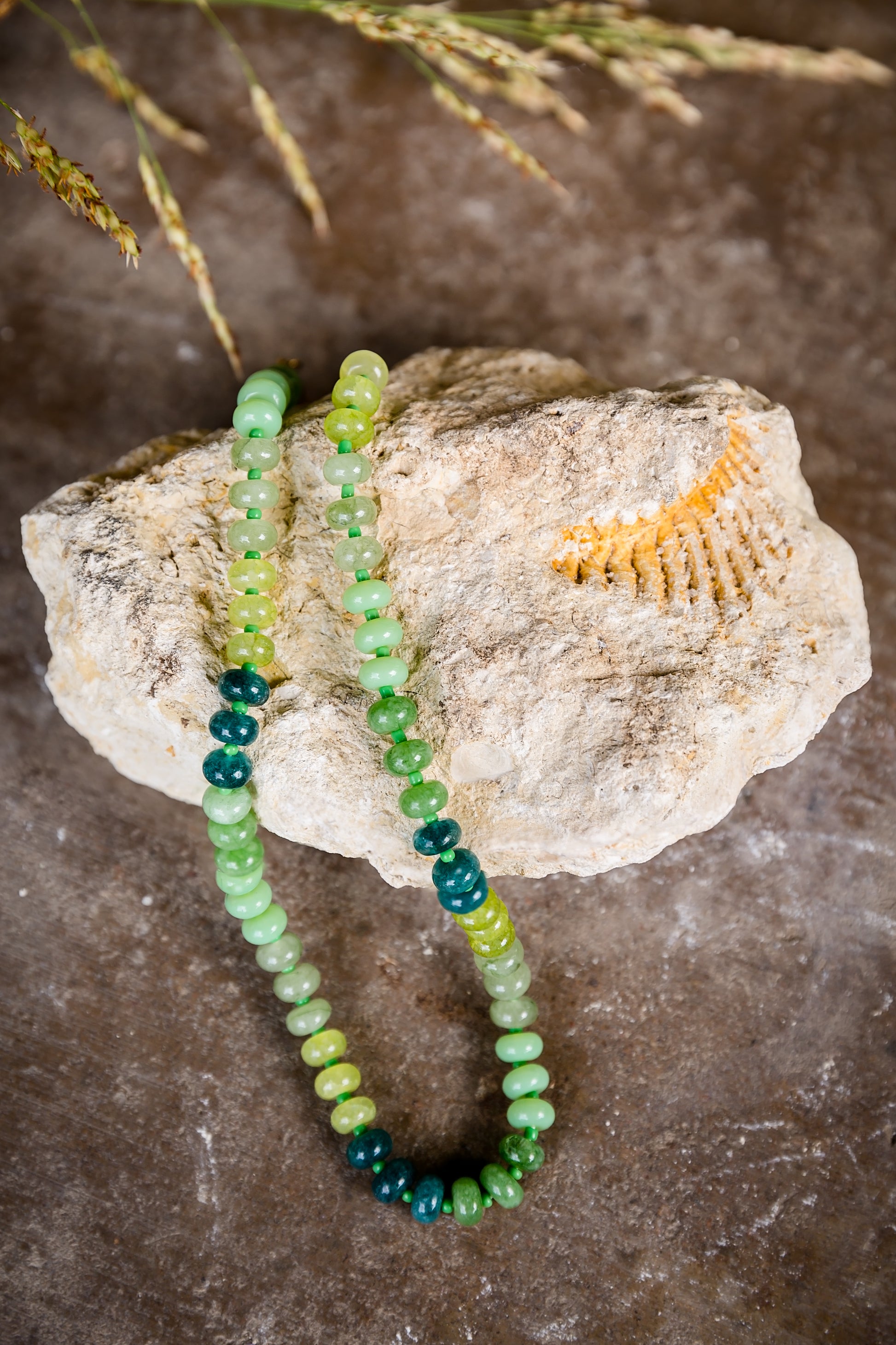 VEITA Jewelry Arden Necklace with genuine green stones and hand-knotted detailing displayed on natural stone