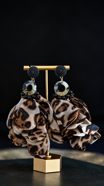 Cheetah Statement Earrings featuring lightweight printed silk, seed bead details and gold-tone accents displayed on an earring stand.