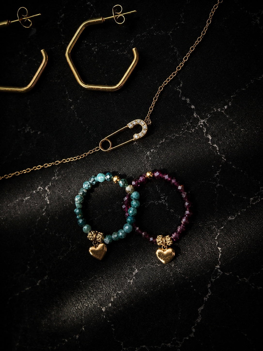 Claire Stretch Rings displayed on a black background paired with Samarrah Hoops  on top and Delicate Salama Bracelet in middle.