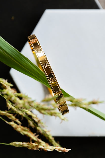 VEITA Jewelry Clover Bangle featuring sparkling zircon clover details on a polished gold bangle