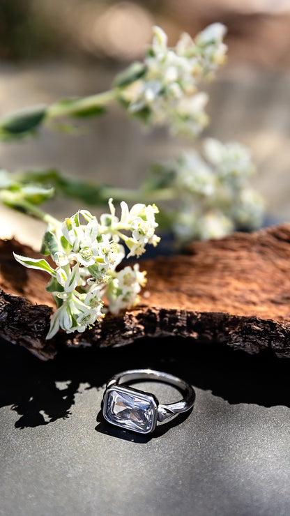 Daydream Ring from the LUNA Collection by VEITA Jewelry in 18kt white gold plating, styled outdoors on stone with greenery.