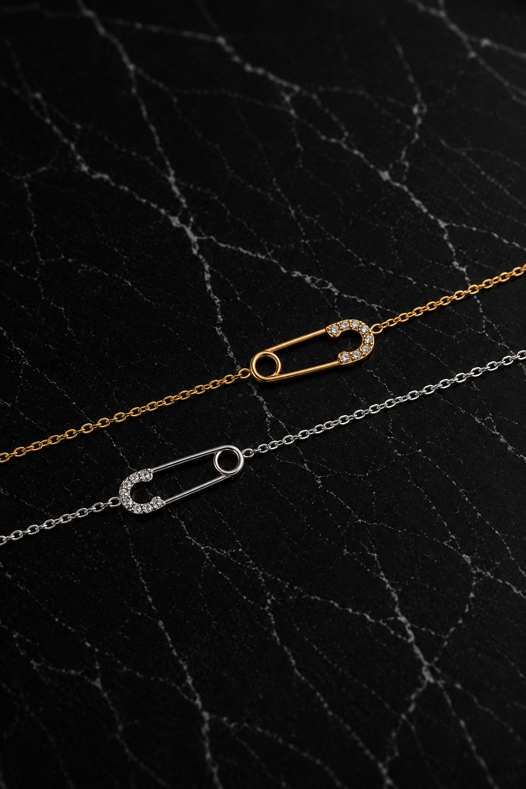 Delicate Salama Bracelet featuring a minimalist safety pin design in gold and silver finishes crafted from stainless steel with zircon accents.