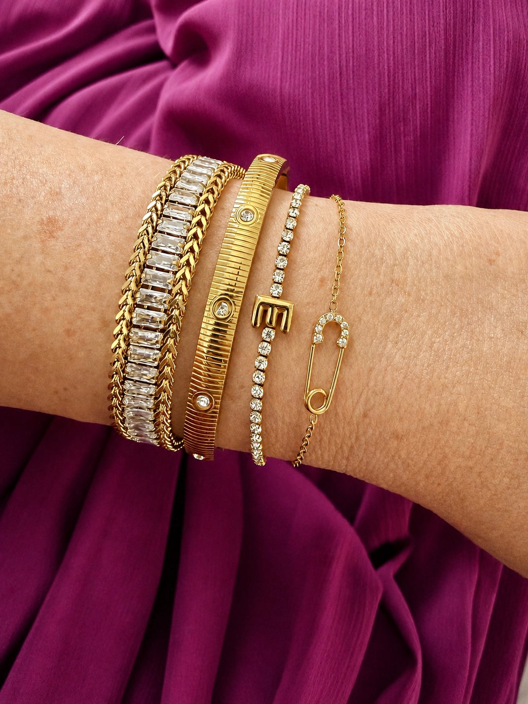 Veita Founder Erin wearing a bracelet stack featuring Delicate Salama Bracelet on the very right.