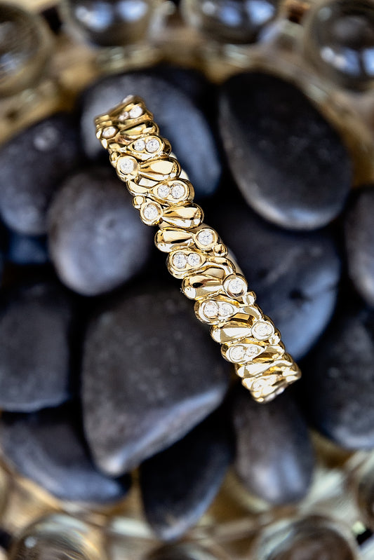 VEITA Jewelry Dolly Bangle featuring sparkling zircon stones set in a polished gold hinged bracelet