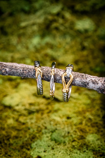 Hames knot ring styled with multiple rings on branch showing stackable design and mixed metal finish