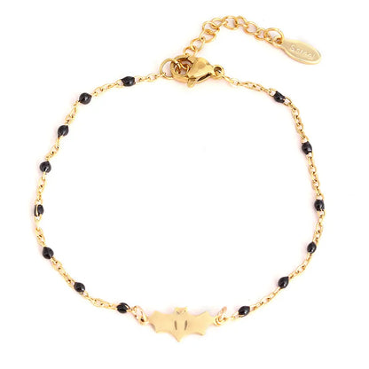 Gold bracelet with black beads on a white background