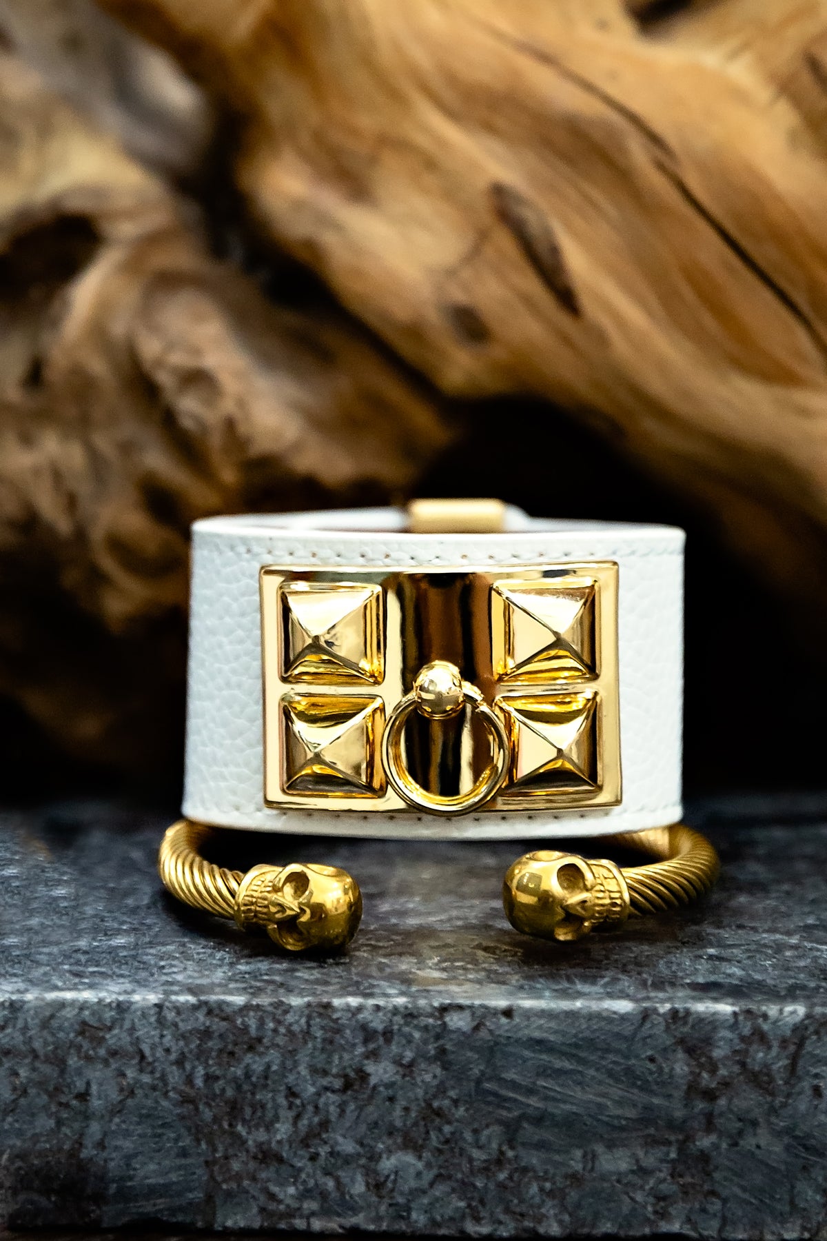 Gold and white decorative item on a dark surface with a brown textured background
