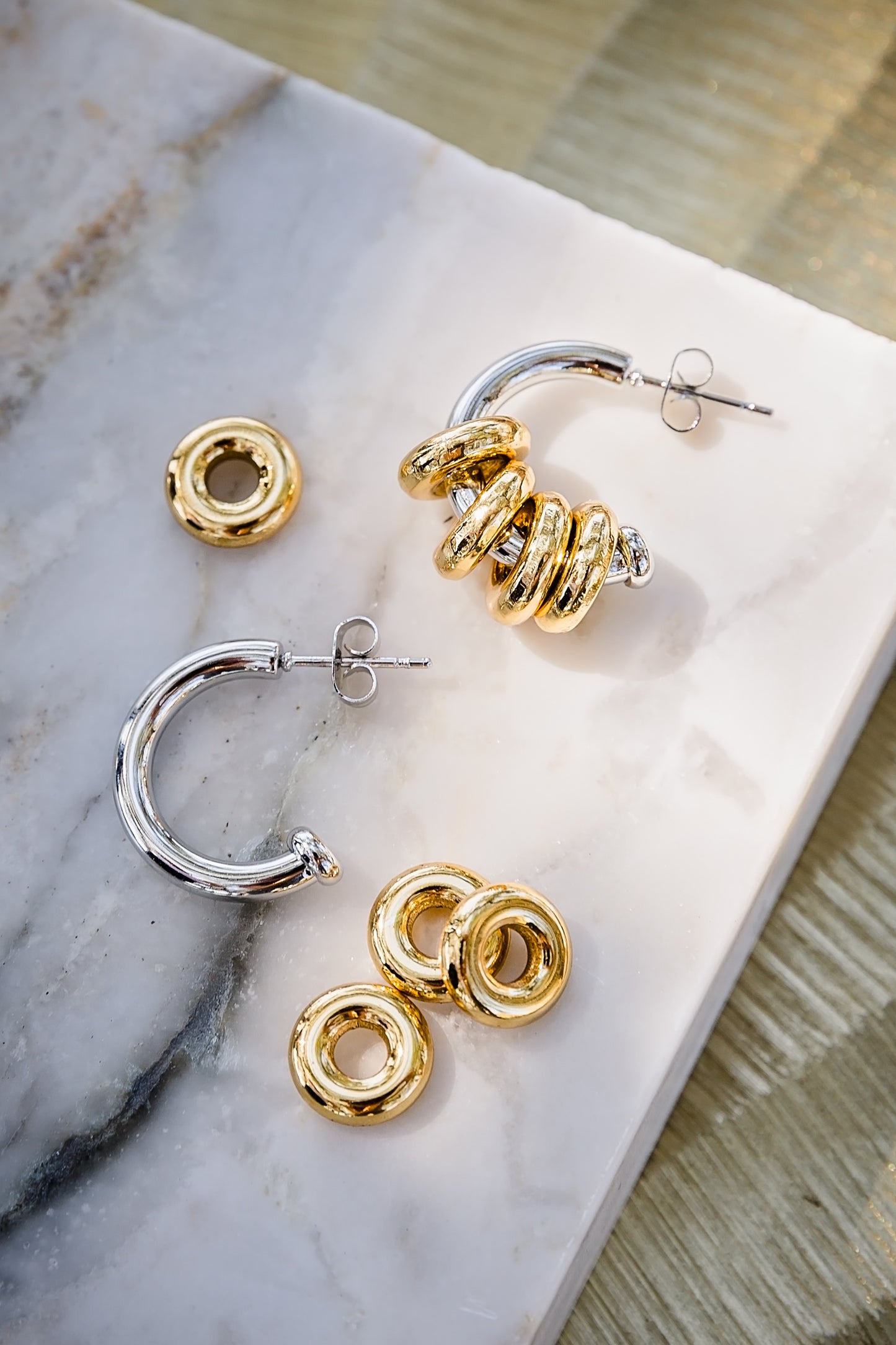 Inez hoop earrings displayed with removable rings showing multiple styling options in gold and silver