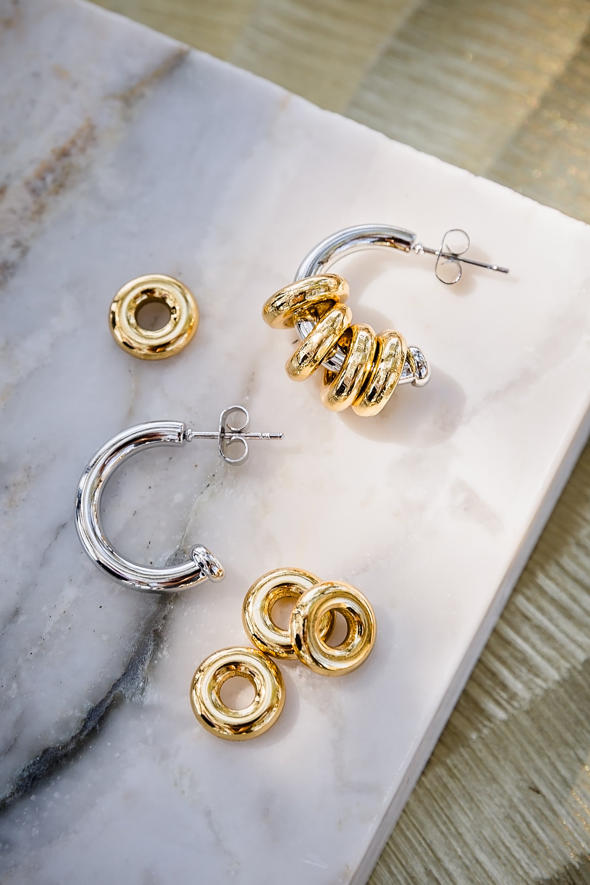 Inez hoop earrings displayed with removable rings showing multiple styling options in gold and silver