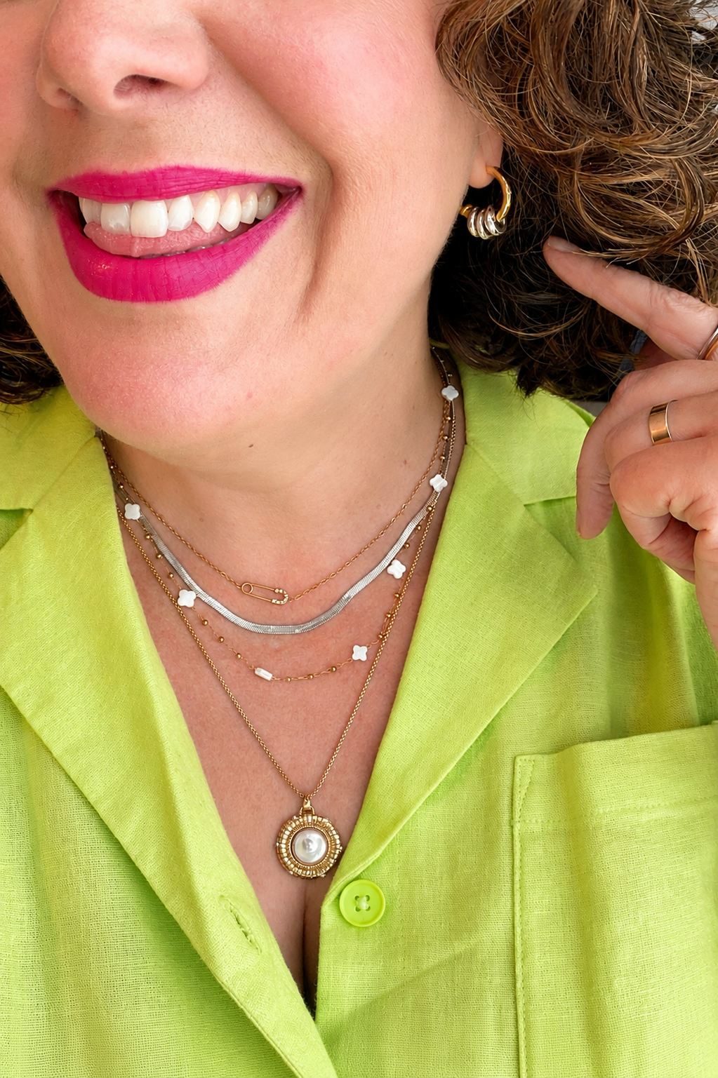 Kate Layering Necklace 3rd down from the top layered with coordinating gold necklaces, featuring delicate mother of pearl accents on an 18kt gold-plated stainless steel chain.