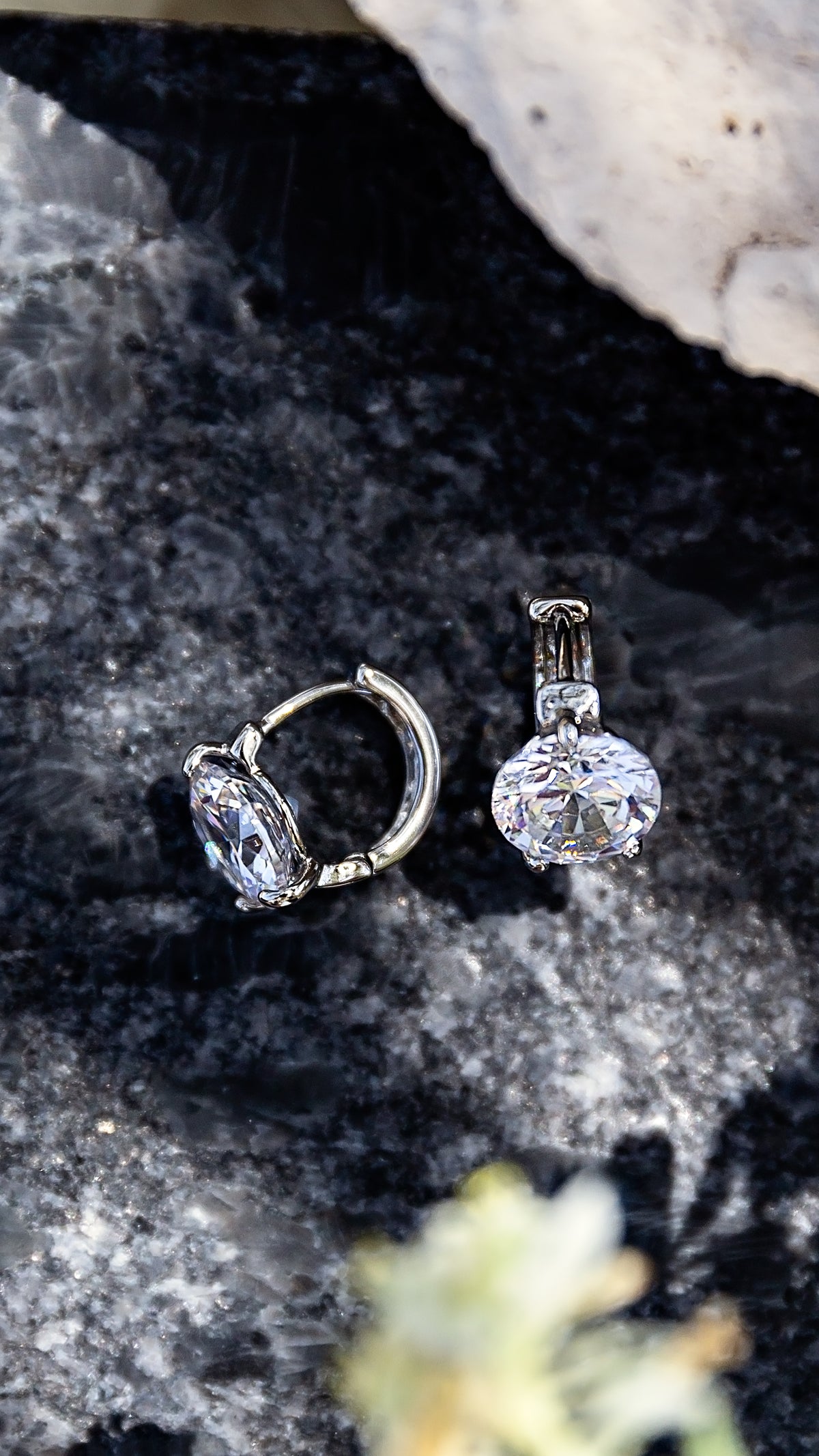 Lumi Huggies from the LUNA Collection by VEITA Jewelry featuring large sparkling zircon stones set in rhodium-plated huggie hoops