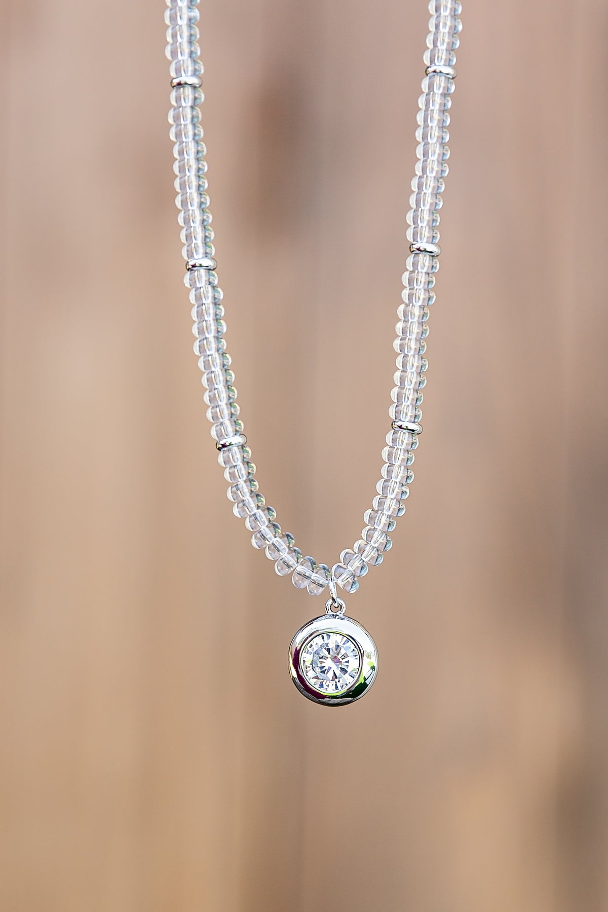 Luna Beaded Necklace by VEITA Jewelry featuring hand-strung clear glass beads and a round genuine zircon pendant with platinum plating.