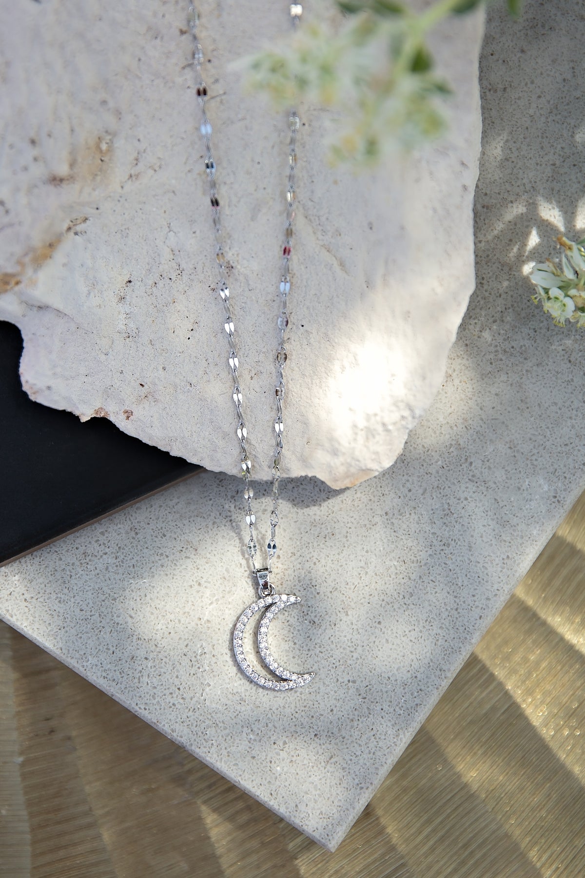 Moonbeam Necklace from the LUNA Collection by VEITA Jewelry featuring a zircon-studded crescent moon pendant on a delicate textured chain.
