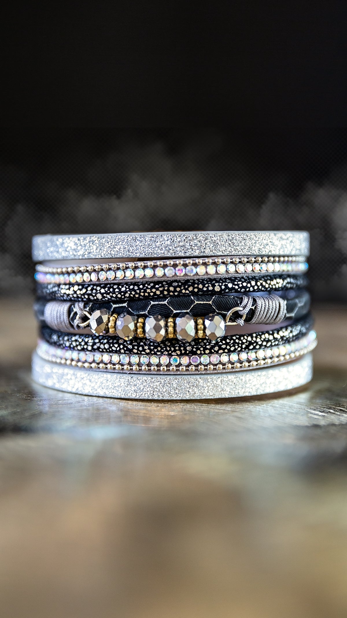 Moonlit Bracelet featuring layered silver-tone rhinestones and glass bead details displayed in a stacked bracelet design.