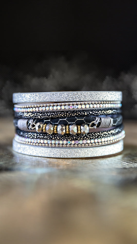 Moonlit Bracelet featuring layered silver-tone rhinestones and glass bead details displayed in a stacked bracelet design.