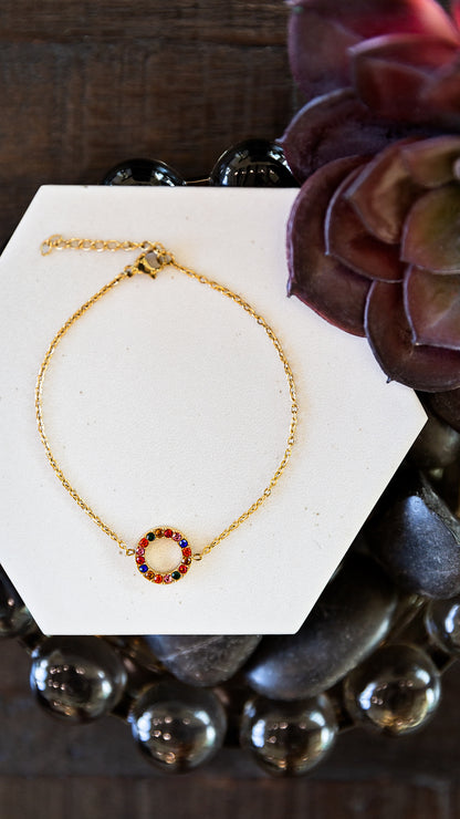 Mosaic Bracelet displayed on a white jewelry stand showing its delicate gold chain and colorful zircon accents