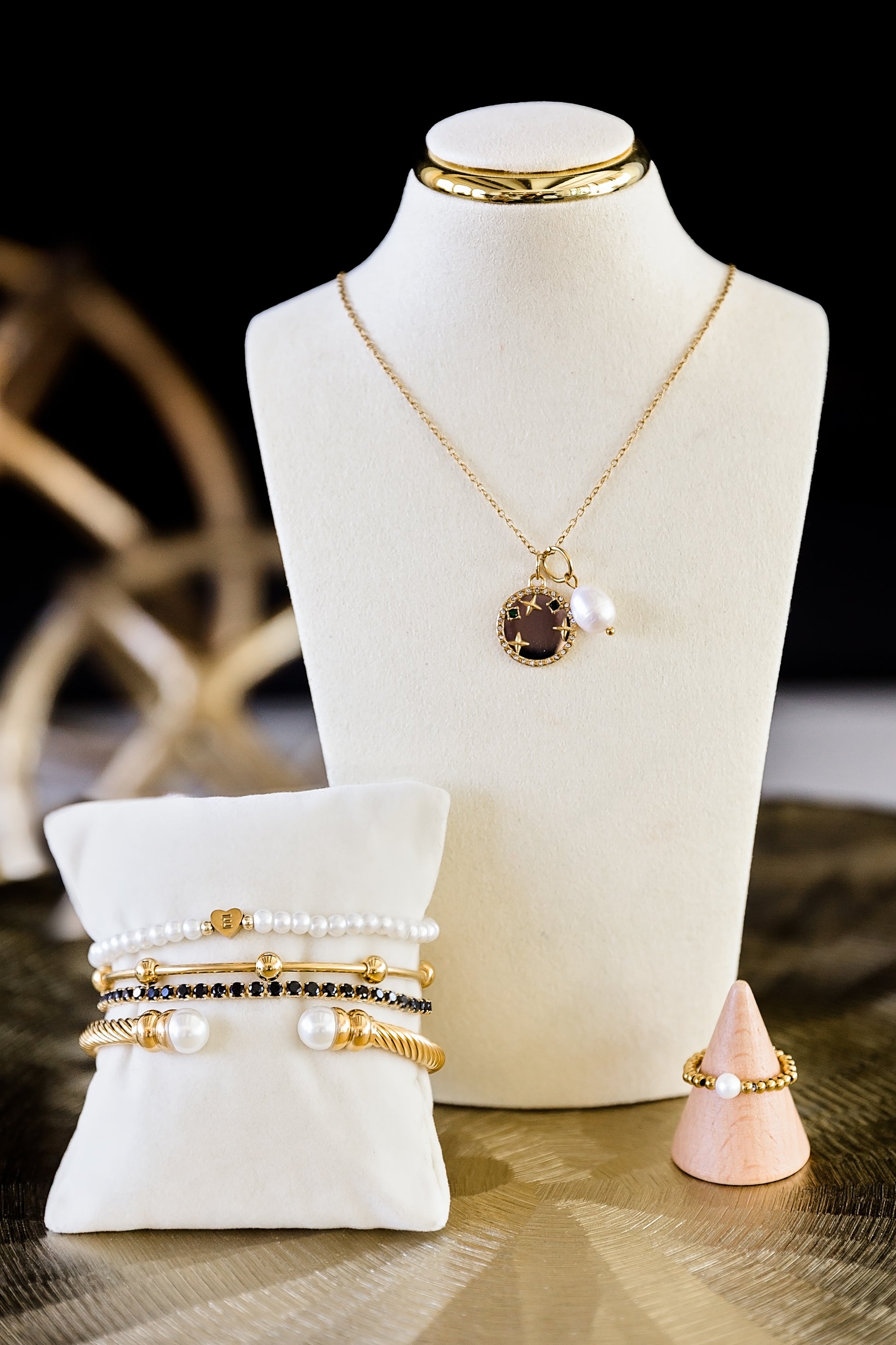 Jewelry set including a necklace, bracelets, and rings displayed on a mannequin bust.