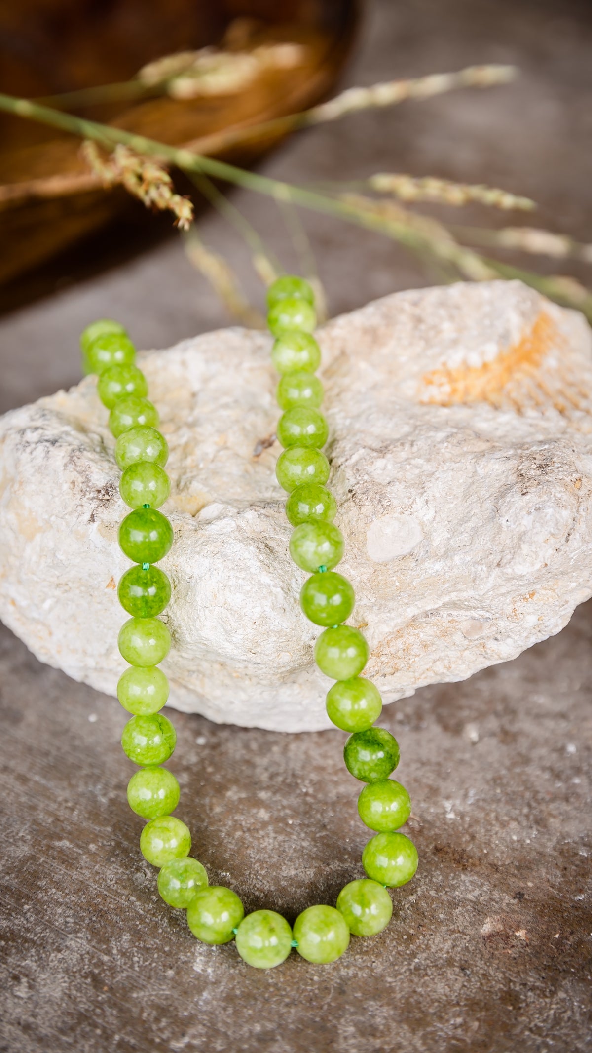 VEITA Jewelry Peridot Necklace featuring vibrant green peridot stones displayed on natural stone