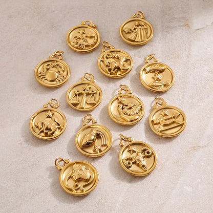 Assortment of gold plated Reversible Zodiac Necklace pendants by VEITA Jewelry showing the zodiac symbol designs.