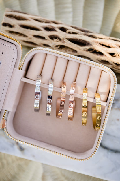 Sabine statement hoop earrings displayed in jewelry case showing textured gold finish and bold shape