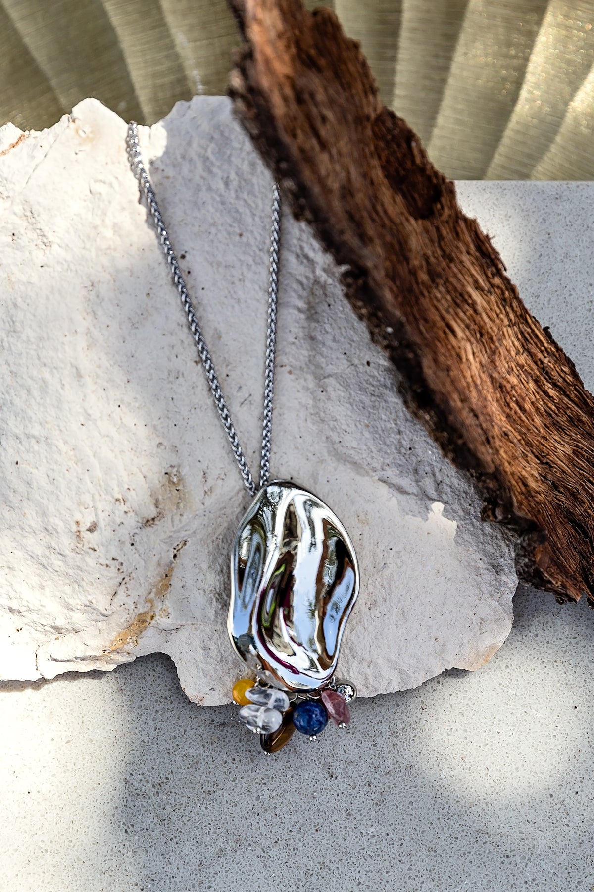 Sculptura Necklace from the LUNA Collection featuring a rhodium-plated sculptural pendant with genuine natural stone accents.