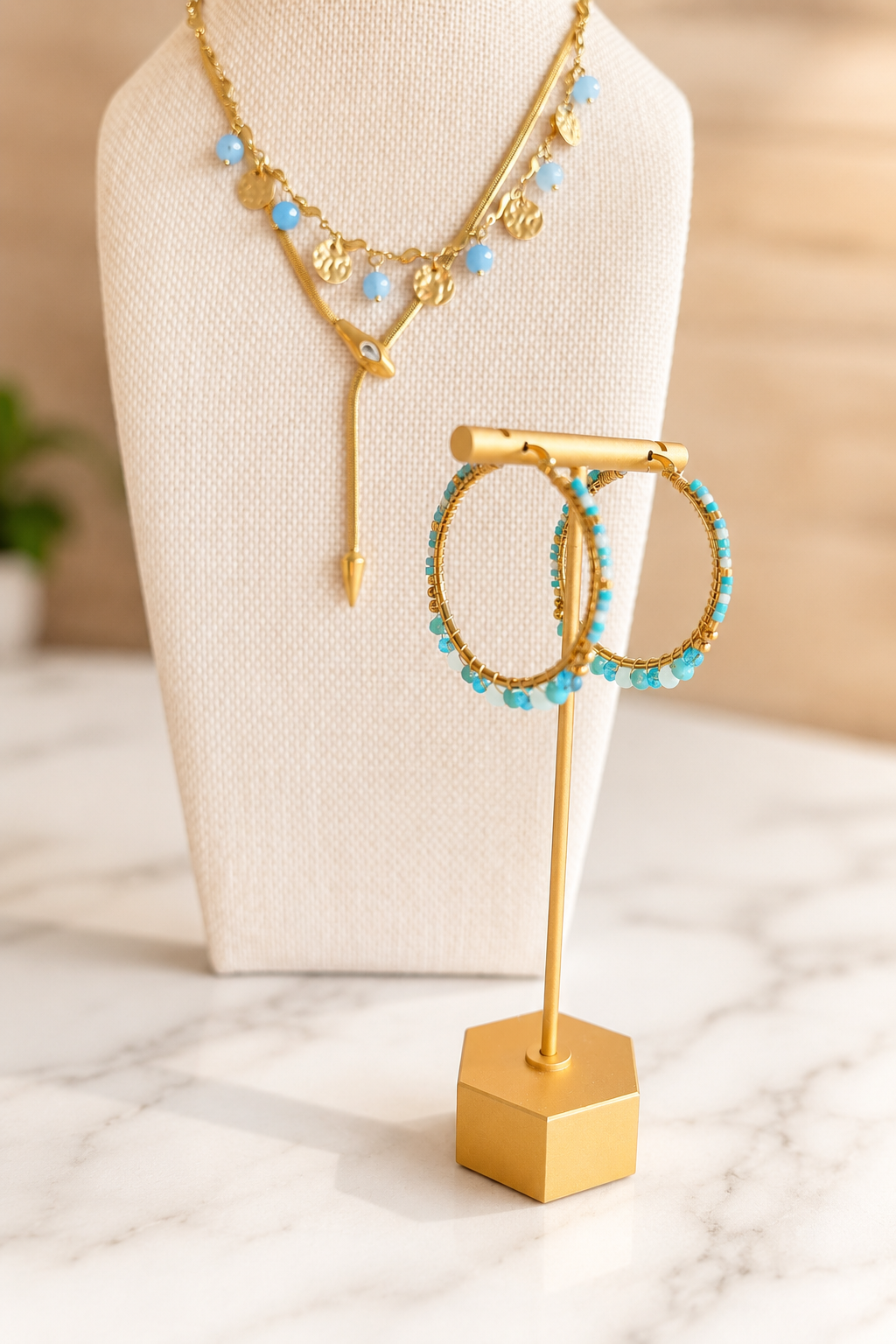 Seaside Necklace paired with coordinating blue beaded earrings, featuring hand-beaded details on 18kt gold plated stainless steel.