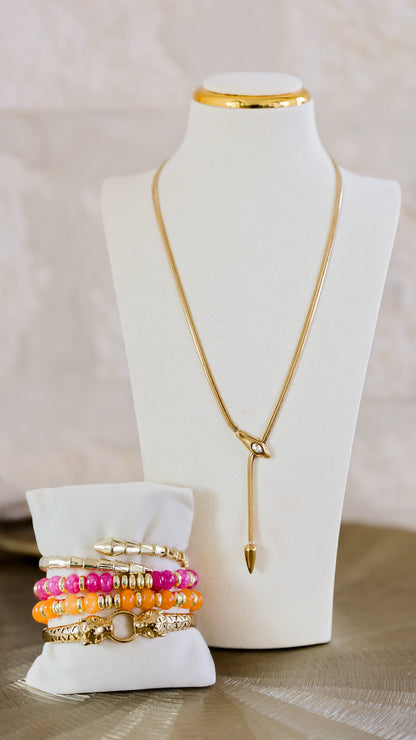 Serpentine necklace worn on jewelry display bust styled with colorful bracelets