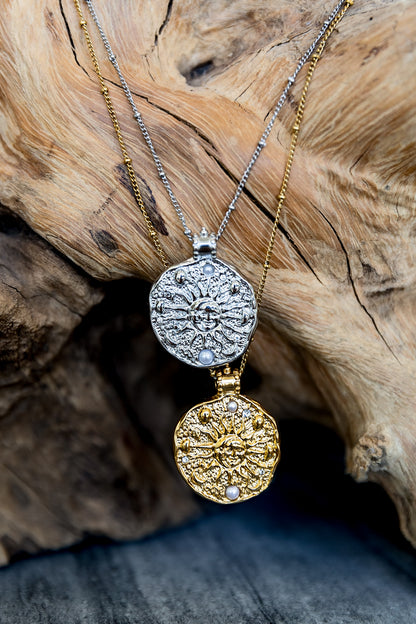 VEITA Jewelry Solana Necklace shown in gold and silver with round celestial sun and moon pendants