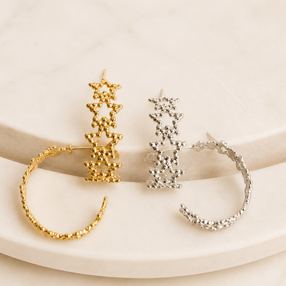 Close-up of the Textured Star Hoops in gold and silver finishes showcasing the textured star details.