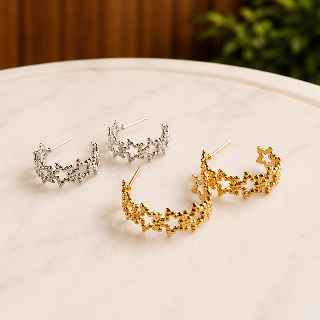 Gold and silver Textured Star Hoops styled together on a marble tray in a lifestyle setting.