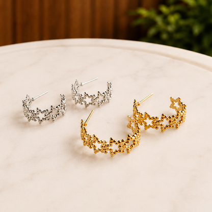 Gold and silver Textured Star Hoops styled together on a marble tray in a lifestyle setting.