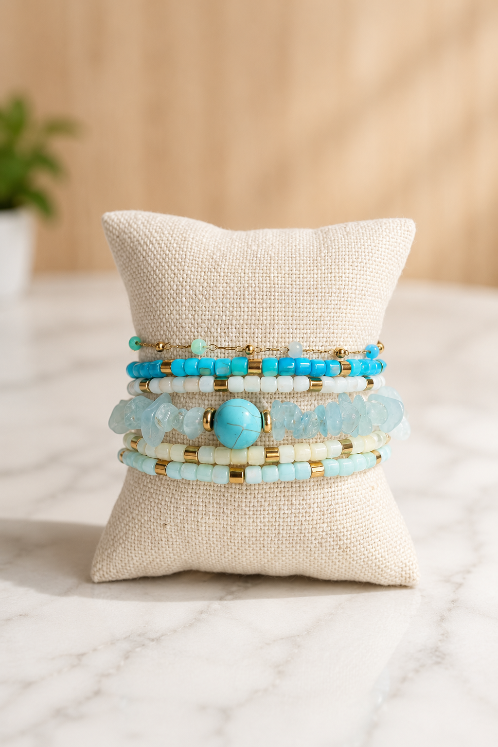 The Stack Edit | Seaside featuring a curated stack of five bracelets with turquoise, natural agate, crystal accents, and 18kt gold plated stainless steel.