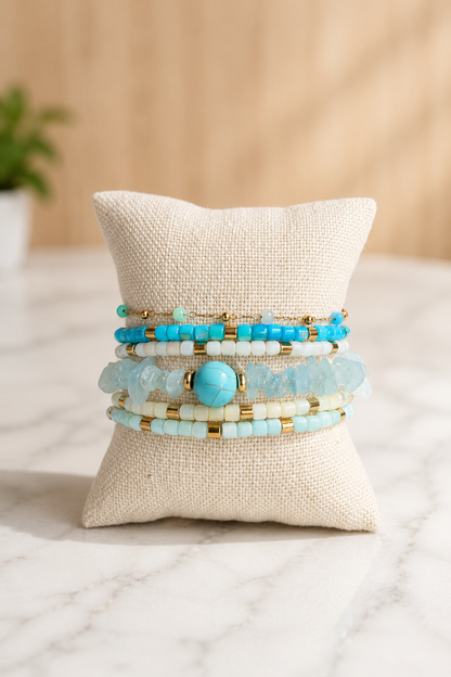 The Stack Edit | Seaside featuring a curated stack of five bracelets with turquoise, natural agate, crystal accents, and 18kt gold plated stainless steel.