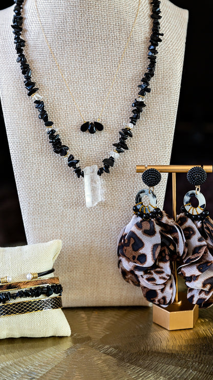 Trine Necklace styled in a layered jewelry look featuring delicate gold chains and gemstone accents.