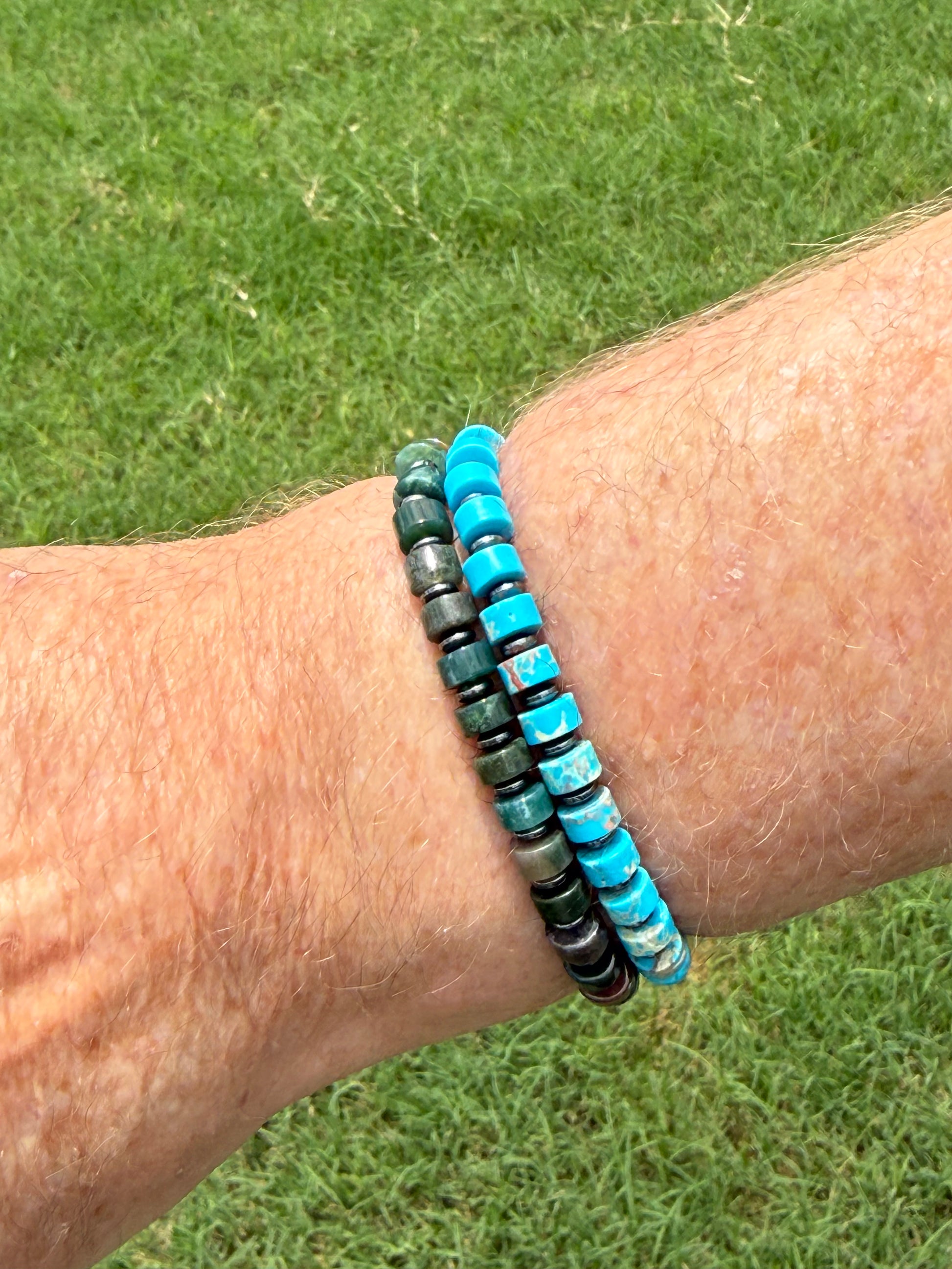 Man wearing the Wayfinder beaded bracelet with genuine gemstone beads and versatile everyday style.