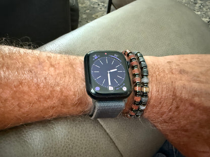 Man wearing the Wayfinder beaded bracelets with genuine gemstone beads and versatile everyday style.
