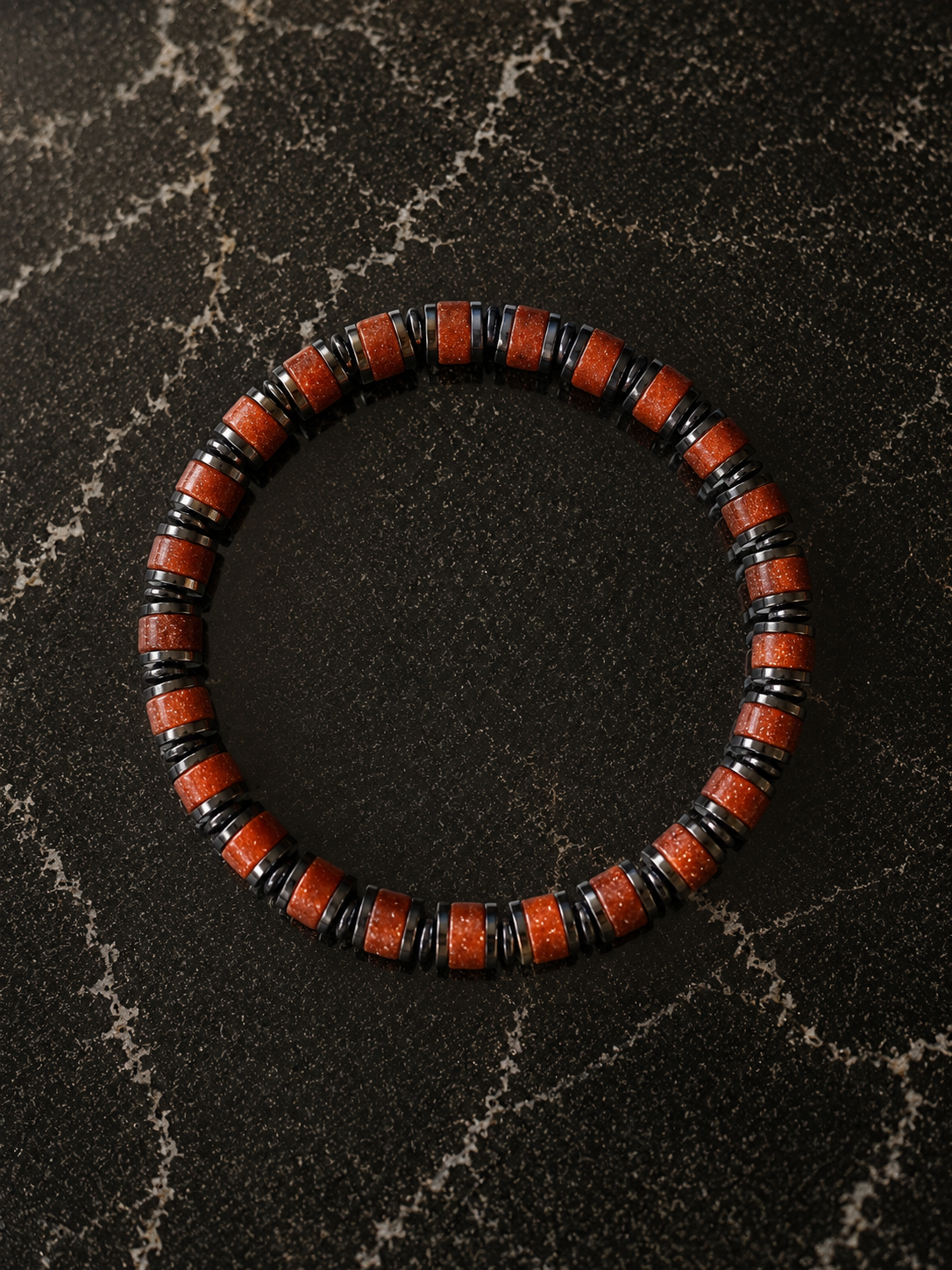 Wayfinder bracelet in Sunstone featuring red gemstone beads and hematite accents for a bold everyday look.